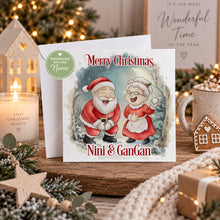Load image into Gallery viewer, Personalised Christmas card featuring Santa and Mrs Claus with Nini and GanGan text