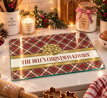 Load image into Gallery viewer, The Bell's Christmas Kitchen tartan glass chopping board displayed on a festive kitchen counter
